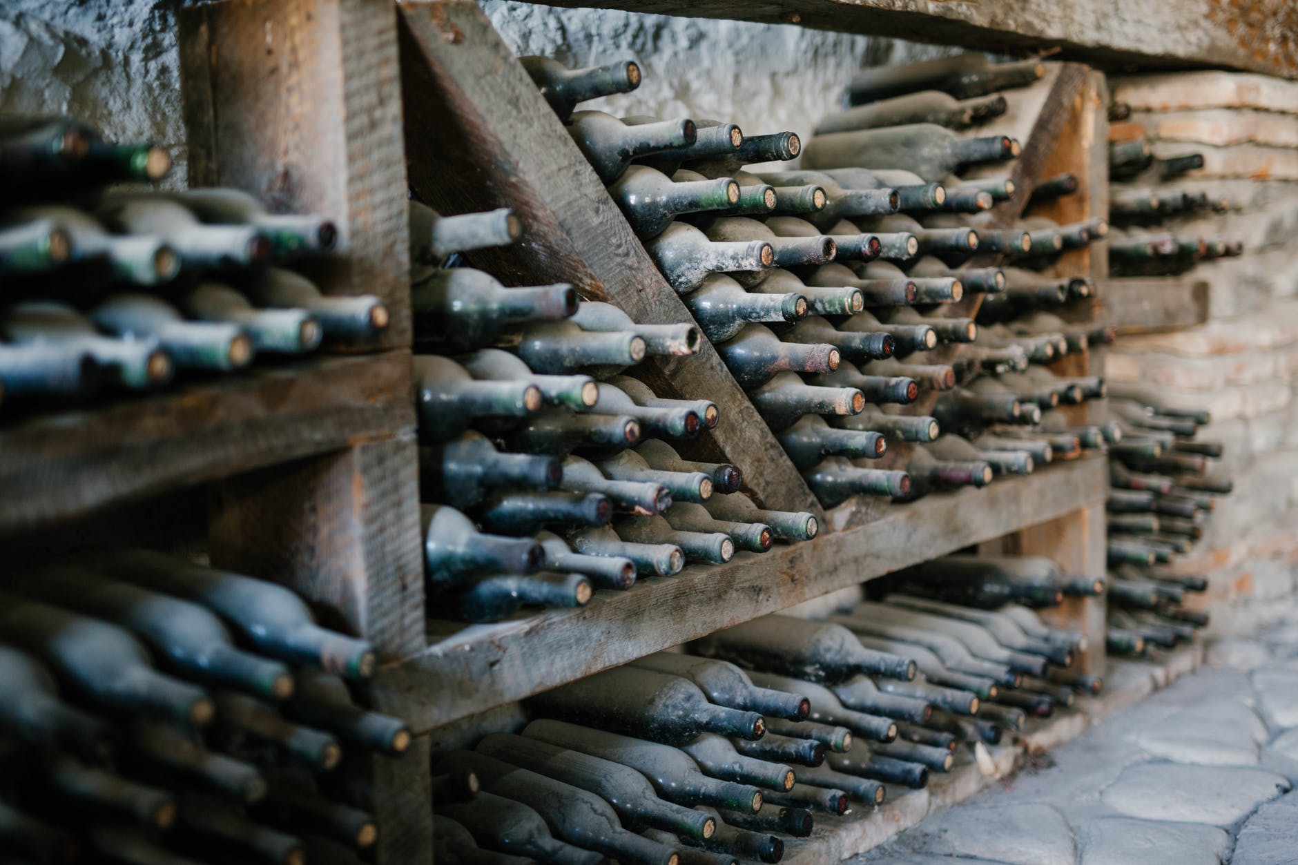 rows of bottles of wine covered with dust